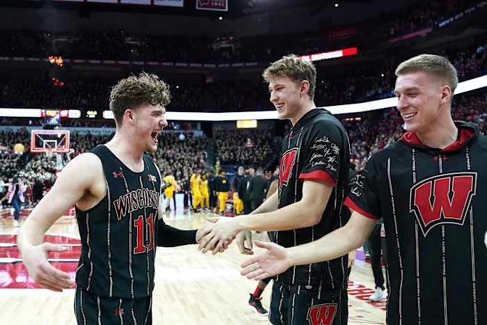 Feb 14, 2023; Madison, Wisconsin, USA; Wisconsin Badgers guard Max Klesmit (11) celebrates a win over the Michigan Wolverines with teammates Markus Ilver (center) and Isaac Lindsey (right) during the second half at the Kohl Center. Mandatory Credit: Kayla Wolf-USA TODAY Sports